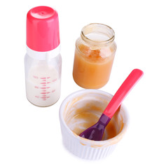 Baby food and milk isolated on white