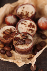 Tasty chocolate candies with coffee beans and nuts, close up