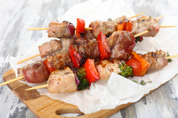 Pork kebab on wooden table close up