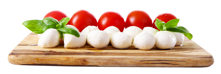 Tasty mozzarella cheese balls with basil and red tomatoes,