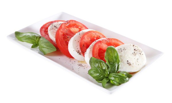 Caprese salad with mozarella cheese, tomatoes and basil