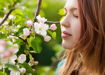 young girl smelling blossoms