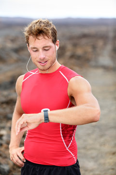 Running man looking at heart rate monitor