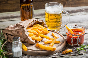 Closeup of homemade fresh fries with cold beer