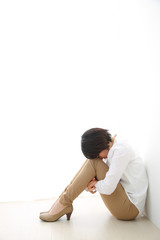 体育座りで悩む女性