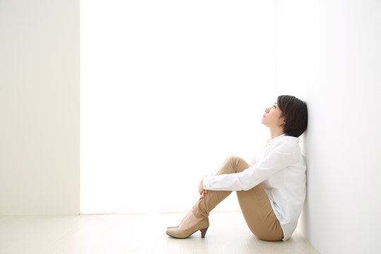 体育座りで悩む女性