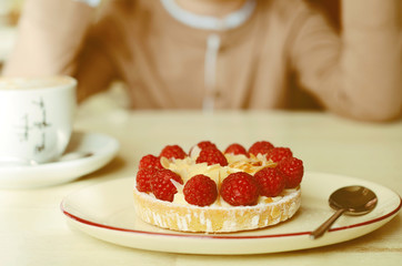 Fresh raspberry and almond tart on a table in cafe