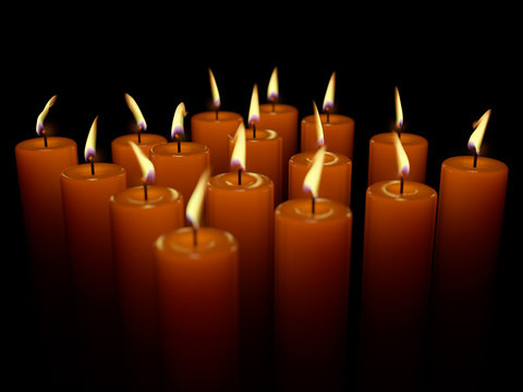Closeup of burning many candle isolated on black background