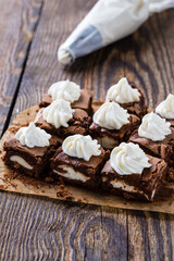 Fototapeta na wymiar Cheesecake brownies with cream cheese swirled frosting