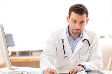 Portrait of a young doctor analysing a radiography