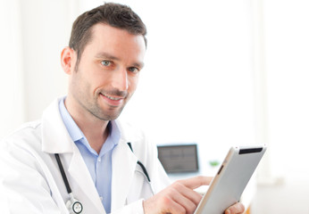 Portrait of a young doctor using tablet at work