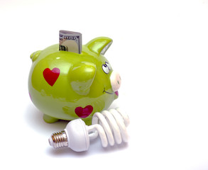 Piggy bank with a CF bulb near (smart energy)