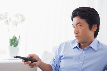 Man relaxing on couch watching tv