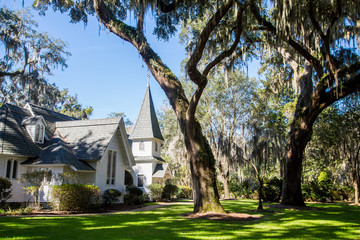 White Church Under Spanish Moss and Green Lawn