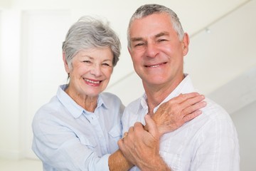 Cute retired couple smiling at camera