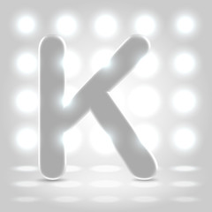 K over lighted background
