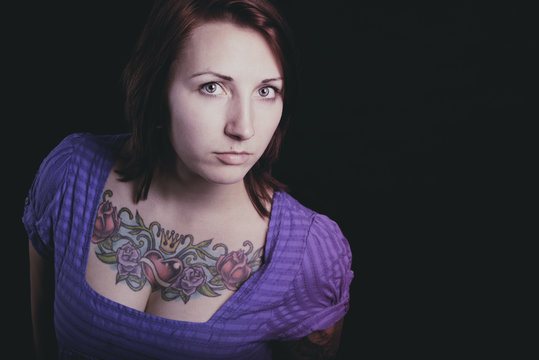 beautiful woman with tattoo in black background