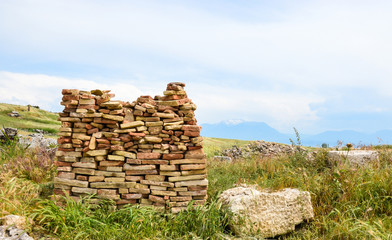 Pile of brick tiles on a meadow