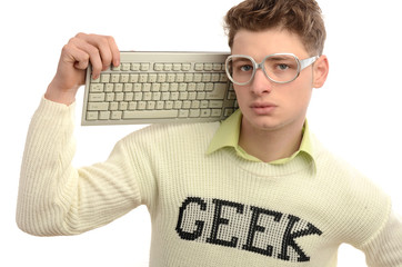 Geek playing video games with keyboard, gamer wearing eyeglasses