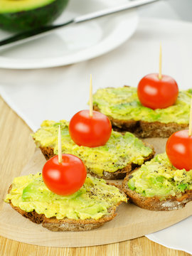 Avocado with tomatoes on seed bread