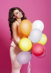 Happy woman holding a lot of balloons