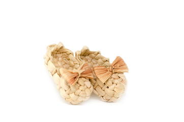 A pair of handmade braided sandals with strawy bow-knot