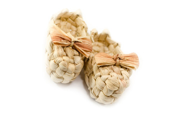 A pair of handmade braided sandals with strawy bow-knot