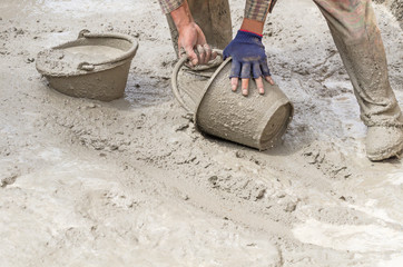 Construction worker mixing cement, Dirty construction work