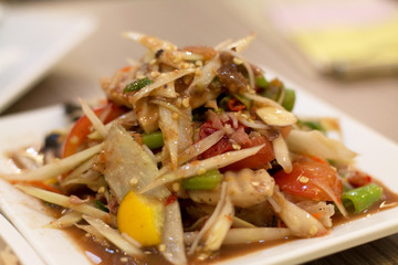 Spicy papaya salad with tomato, sausage and morning glory