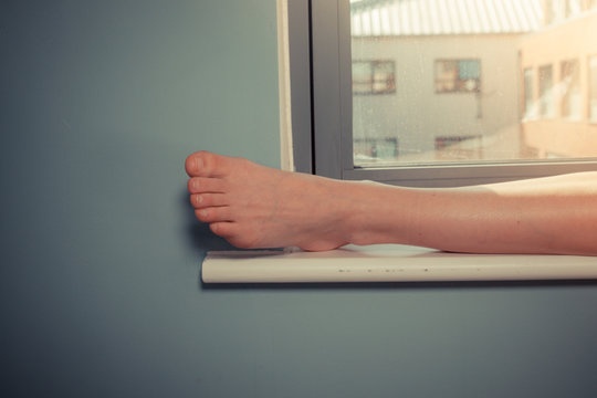 Woman's foot on window sill