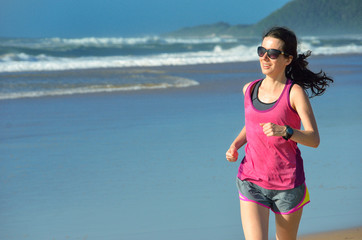 Woman running on beach, beautiful girl runner jogging outdoors