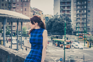 Pretty girl sitting on a concrete wall