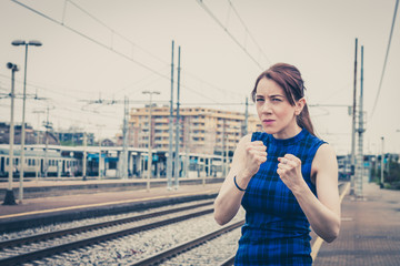 Pretty girl ready to fight along the tracks