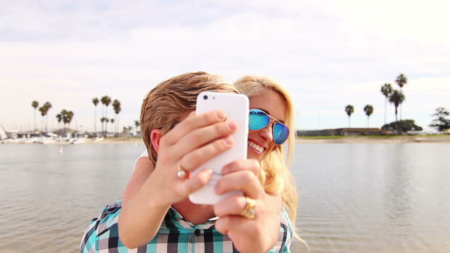 Young Happy Couple Taking Selfie At Beach