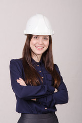 Portrait of a girl engineer in helmet