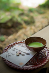 Japanese green tea setting on wooden bench.