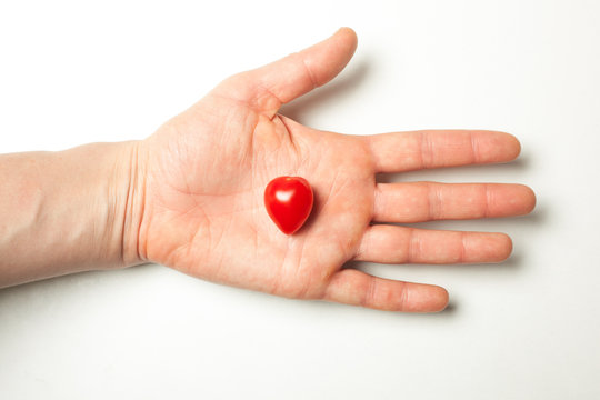 Hand holding heart shaped tomato