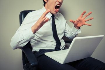 Businessman angry at laptop