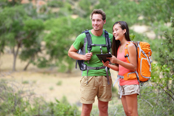 Tablet computer - couple hiking using internet app