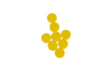 Arrow of yellow pills on white background
