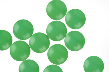 Green pills on white background