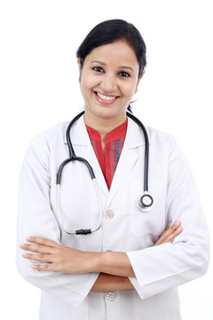 Young female doctor against white background