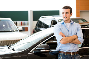 man standing near a car