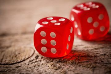 Pair of thrown red dices on old wooden table