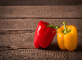 Colored bell peppers on wooden table