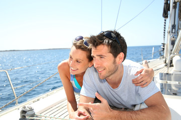 Couple relaxing on sailboat deck