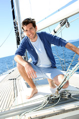 Smiling handsome man on sailboat
