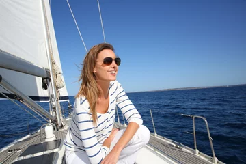Aluminium Prints Sailing Attractive modern woman enjoying sailing cruise