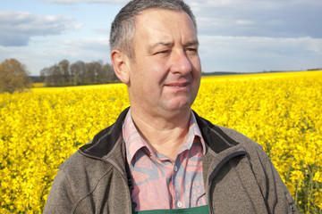 Farmer stands in rape field