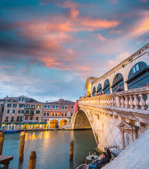 Wonderful wide angle view of Rialto Bridge on a cloudy sunset -